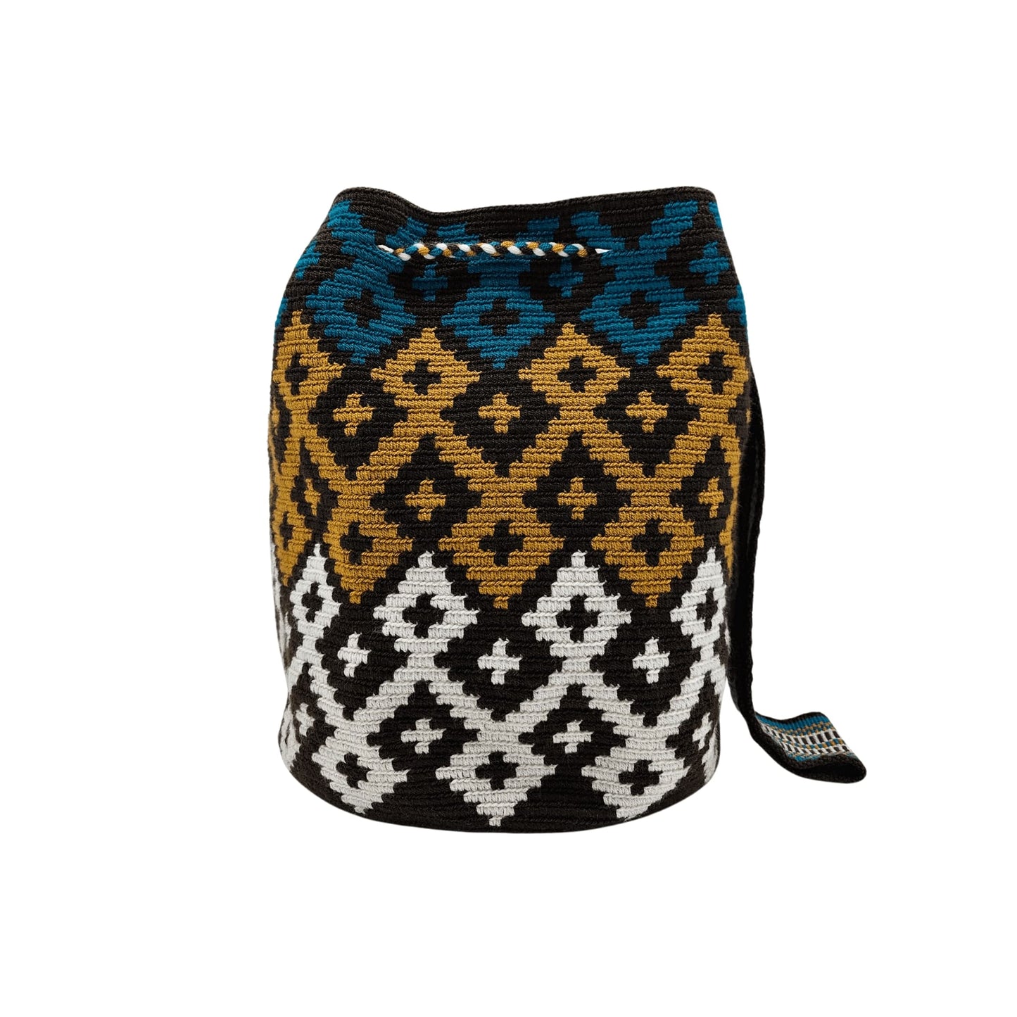 A handmade Wayuu mochila bag with an intricate geometric pattern in black, white, mustard yellow, and teal blue. The cylindrical bag has a woven shoulder strap and a drawstring closure adorned with matching tassels.