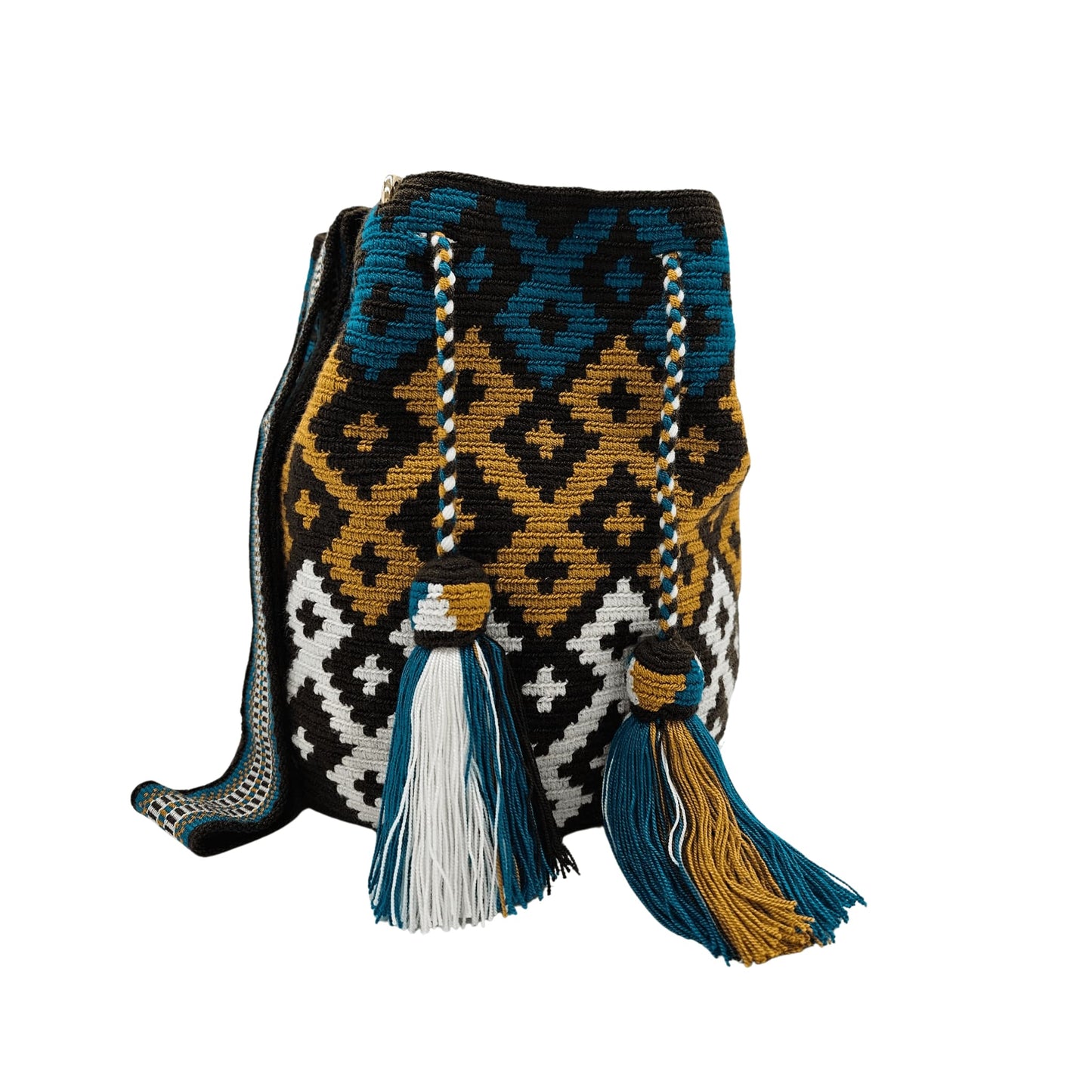 A handmade Wayuu mochila bag with an intricate geometric pattern in black, white, mustard yellow, and teal blue. The cylindrical bag has a woven shoulder strap and a drawstring closure adorned with matching tassels.