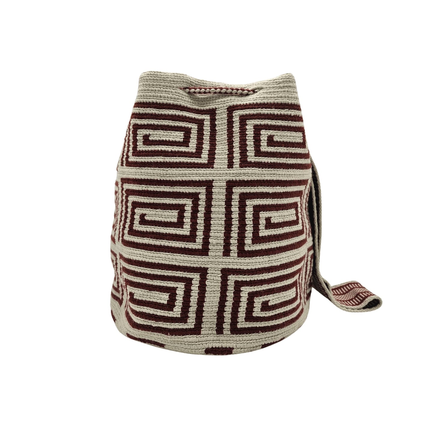 A beige Wayuu Mochila bag with a brown geometric pattern. It has a drawstring closure with tassels.