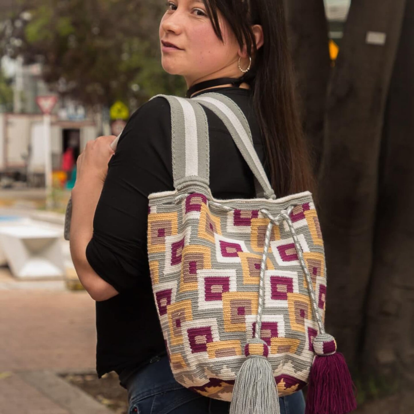 Discover the enchanting Dawn Wayuu Mochila Bag featuring shades of gray, vanilla, burgundy, and dusty pink. This bag boasts a modern design and a truly unique combination of colors, making it a standout accessory.