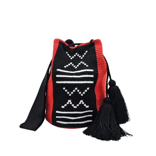 Artisan-made Wayuu mochila bag, showcasing intricate black and red crochet work with white accents and tassel embellishments.