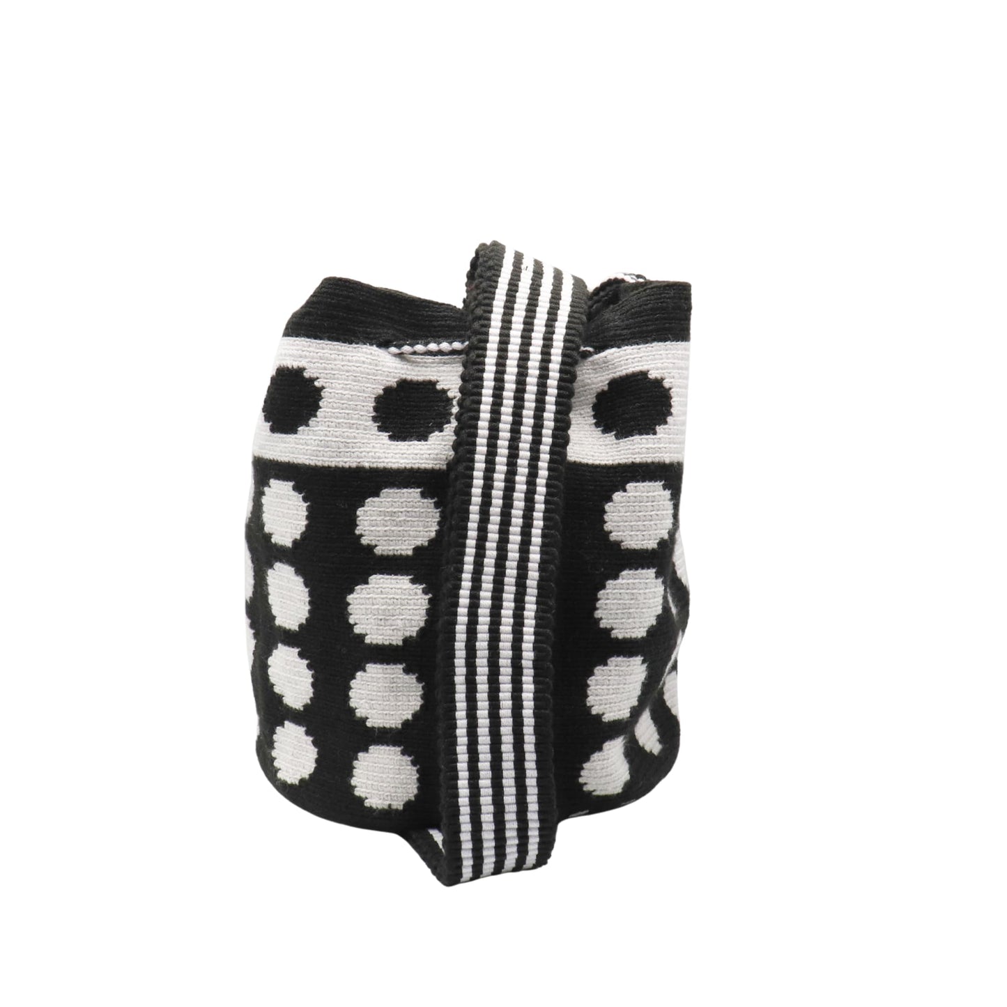 Black and white handmade Wayuu bag with dotted pattern and striped strap.