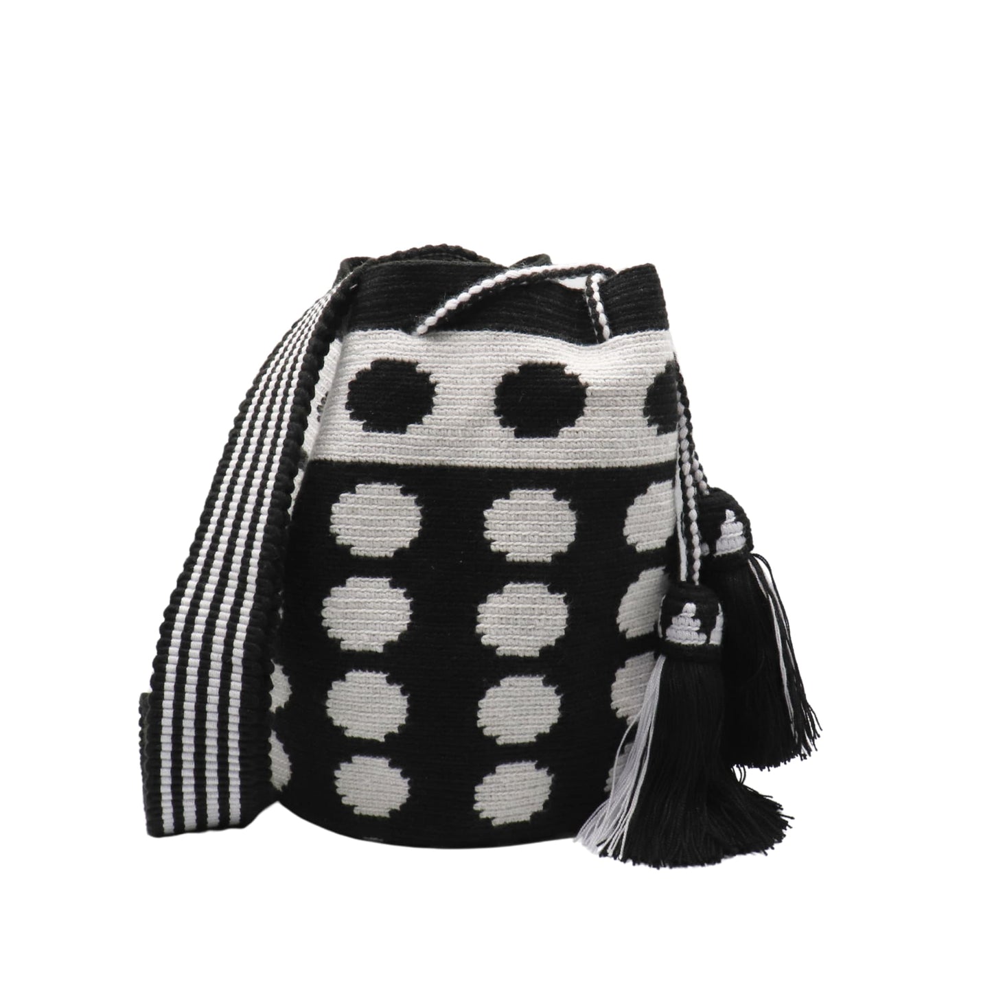 Black and white handmade Wayuu bag with dotted pattern and striped strap.