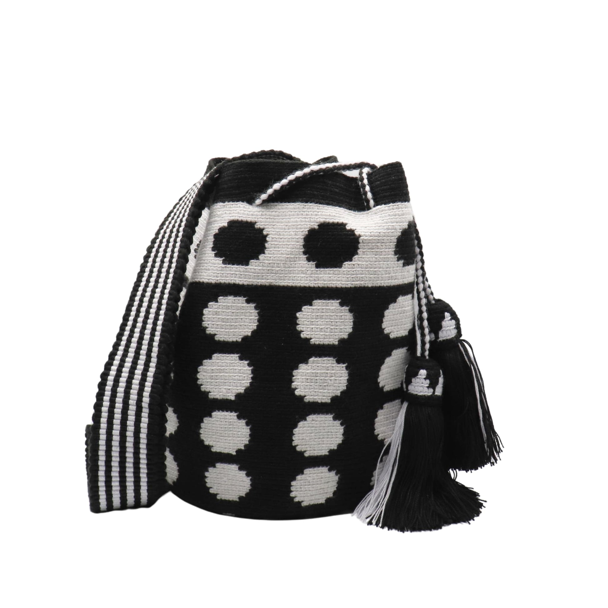 Black and white handmade Wayuu bag with dotted pattern and striped strap.