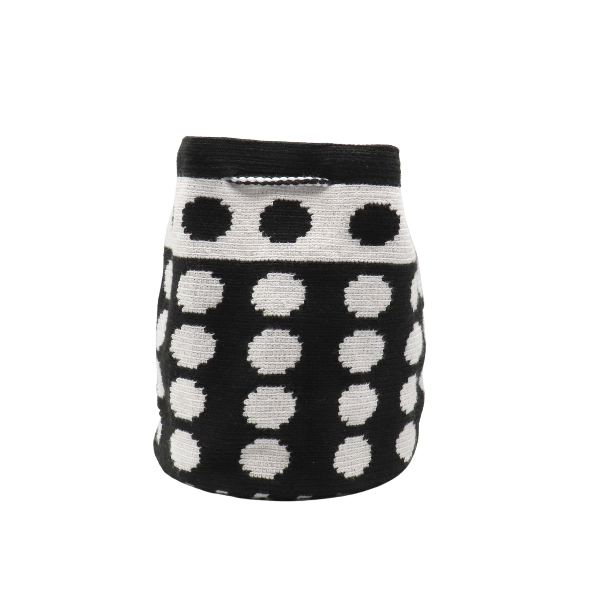 Black and white handmade Wayuu bag with dotted pattern and striped strap.