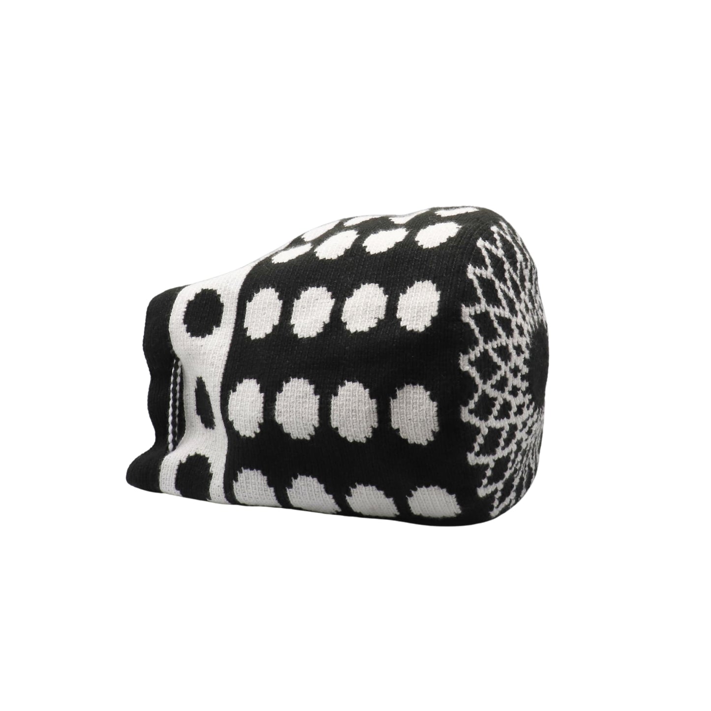 Black and white handmade Wayuu bag with dotted pattern and striped strap.