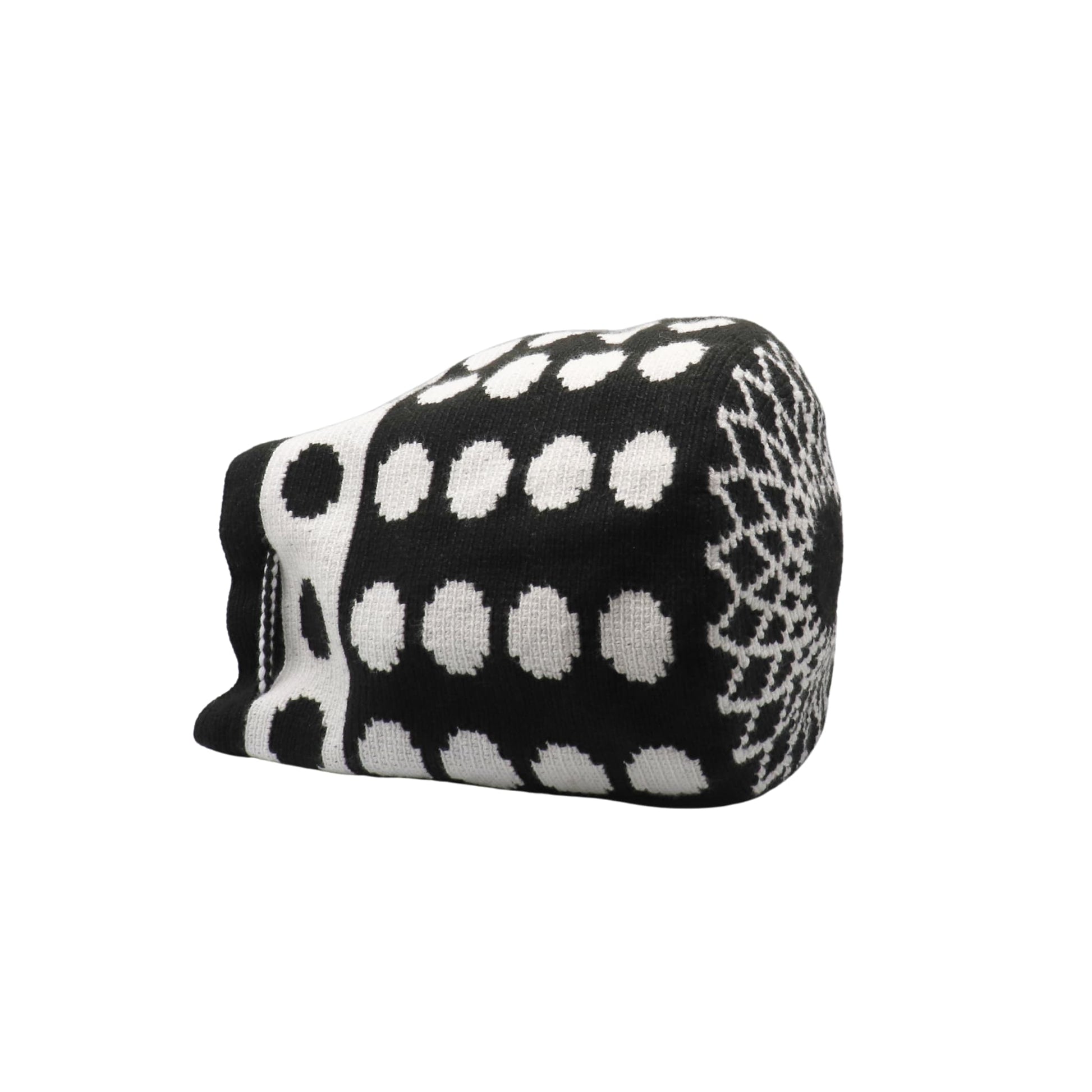 Black and white handmade Wayuu bag with dotted pattern and striped strap.