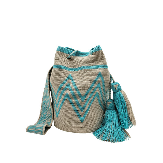 A simple yet captivating beige Wayuu bag adorned with aqua patterns, showcasing a minimalist design with intricate woven details.