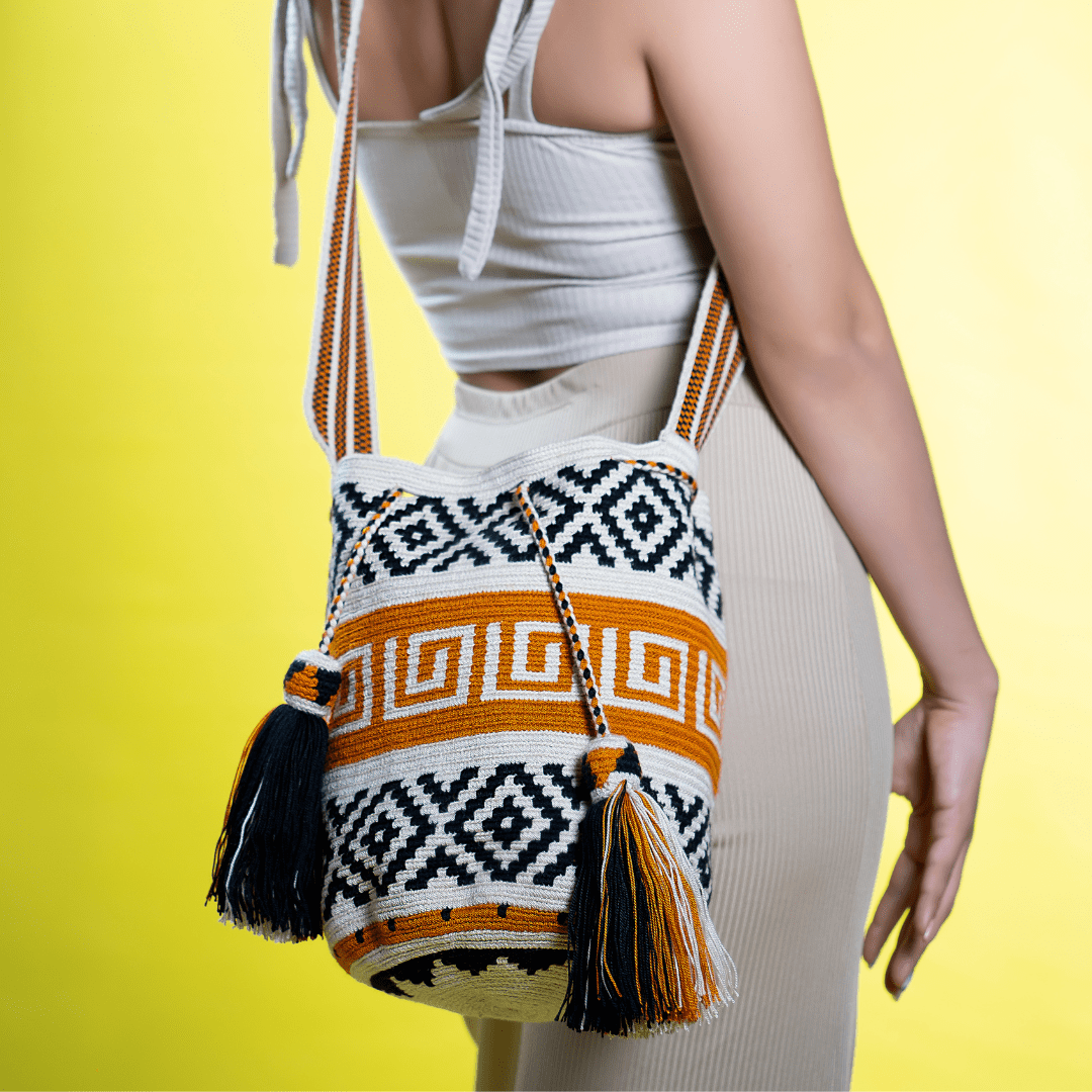 Handmade Wayuu bag in earth tones with a geometric design. Skillfully woven with natural colors, it’s a functional piece of art that highlights the traditional craftsmanship of Wayuu artisans, blending cultural heritage with contemporary style.