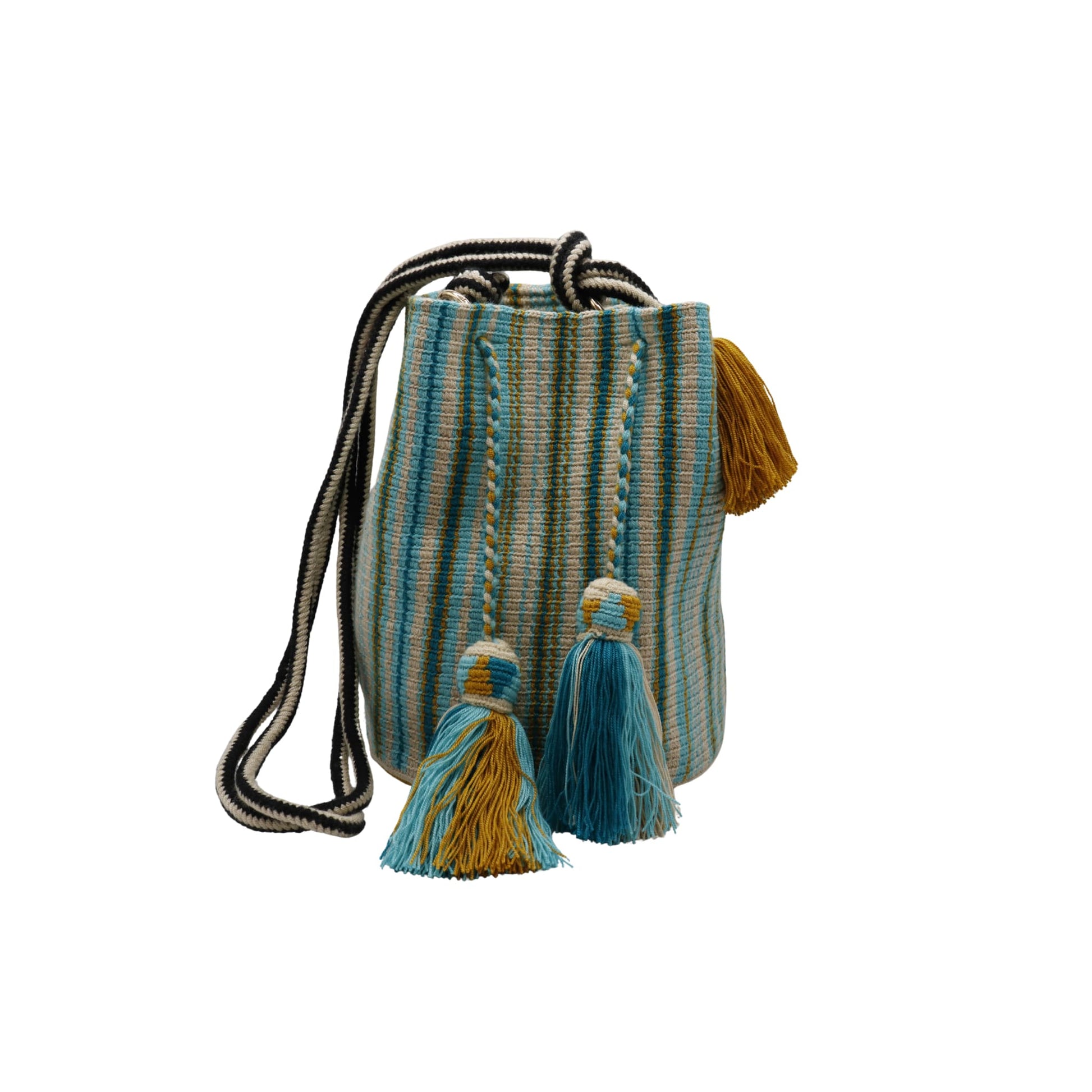 A handcrafted Wayuu bag with a vibrant striped pattern in turquoise, white, and yellow. The bag features a single long, braided black-and-white shoulder strap, a drawstring closure, and decorative tassels with a black pompoms accent.