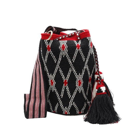 A handmade crocheted Wayuu bucket bag from Colombia. It features a bold geometric design and a long strap for easy carrying.
