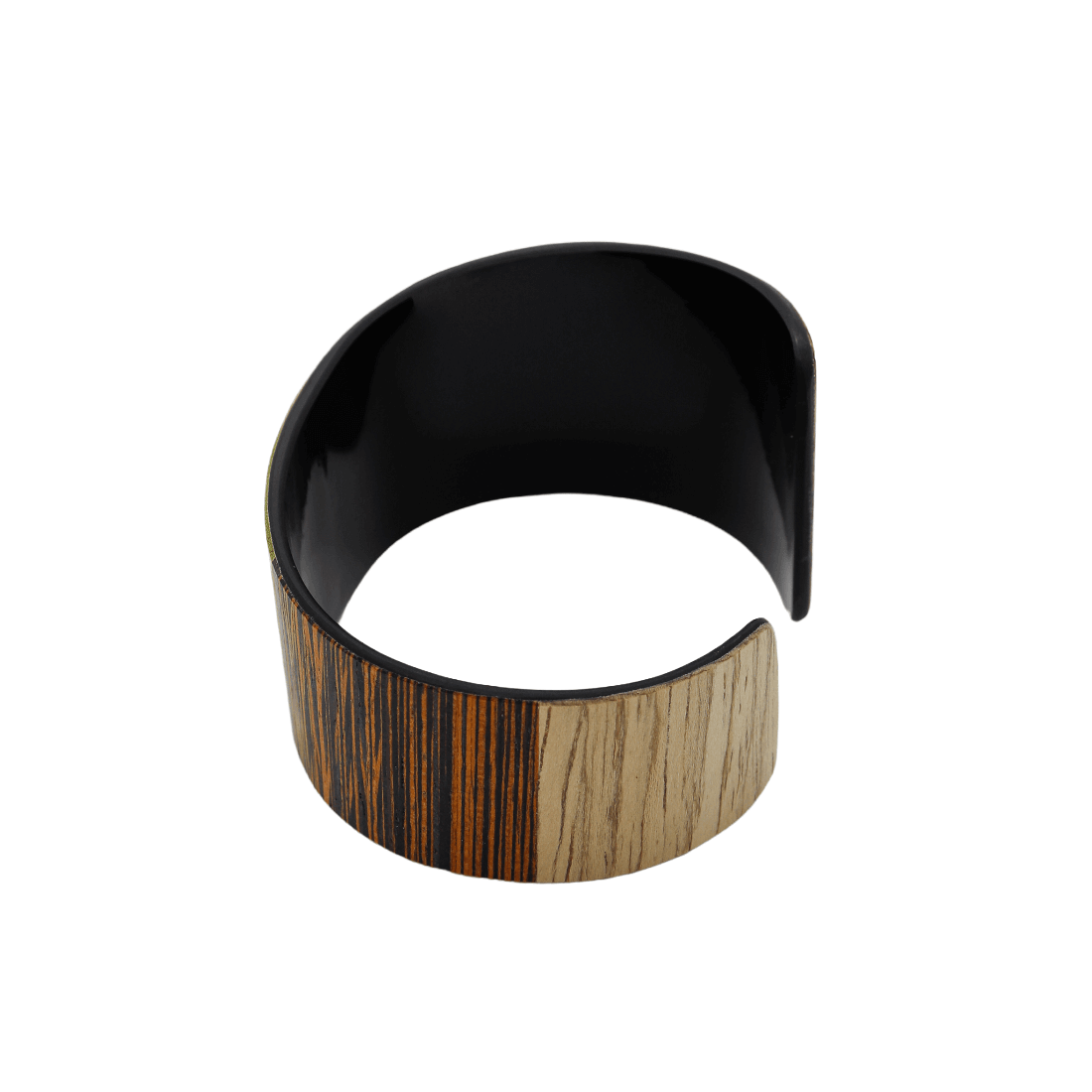 A wide open cuff bracelet featuring a glossy black interior and a split exterior design with a dark brown and black striped wood grain on one side and a light tan wood grain on the other, shown on a plain white background.