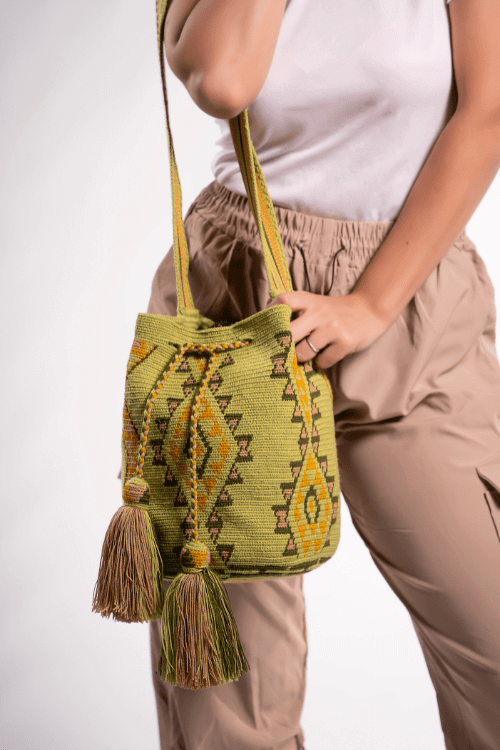 Colorful Wayuu bag with a geometric design in green and brown shades.