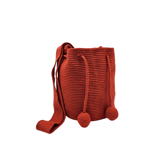 Medium-sized Wayuu bag in solid red color, featuring beautiful pom poms for drawstring closure.