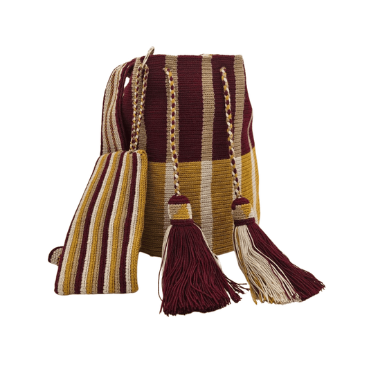 A handmade Wayuu bag in earthy tones of brown, beige, and rust, showcasing intricate weaving patterns and vibrant accents, representing authentic Colombian craftsmanship.