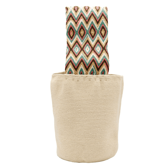 A solid beige Banu Wayuu Colombian Bag with a wide macramé handle adorned with vibrant colors. The bag features a wide short strap, making it a bold statement piece that beautifully complements the bag's body.