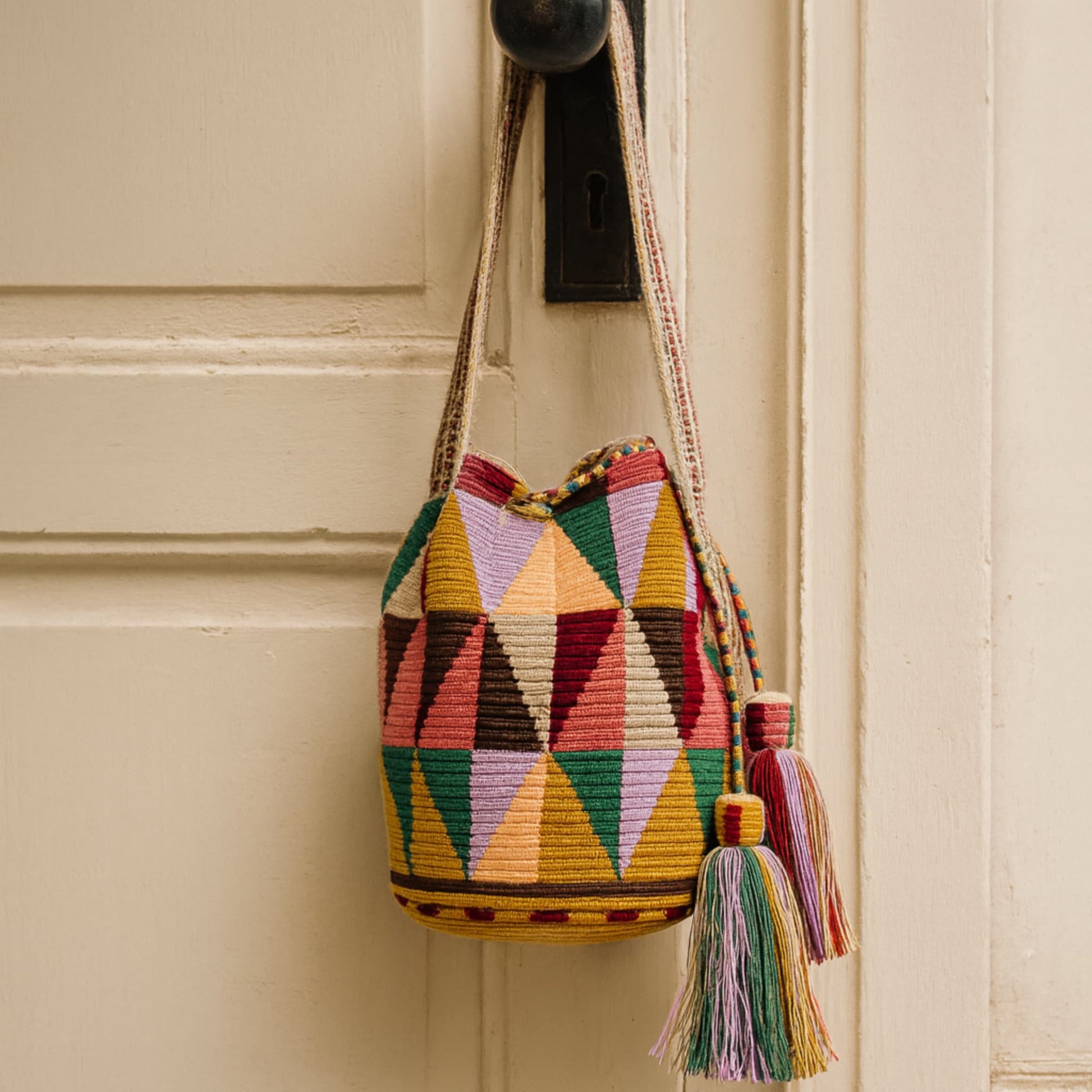 Handmade Wayuu bag with intricate patterns, crafted by Colombian artisans, featuring vibrant colors and authentic cultural designs.