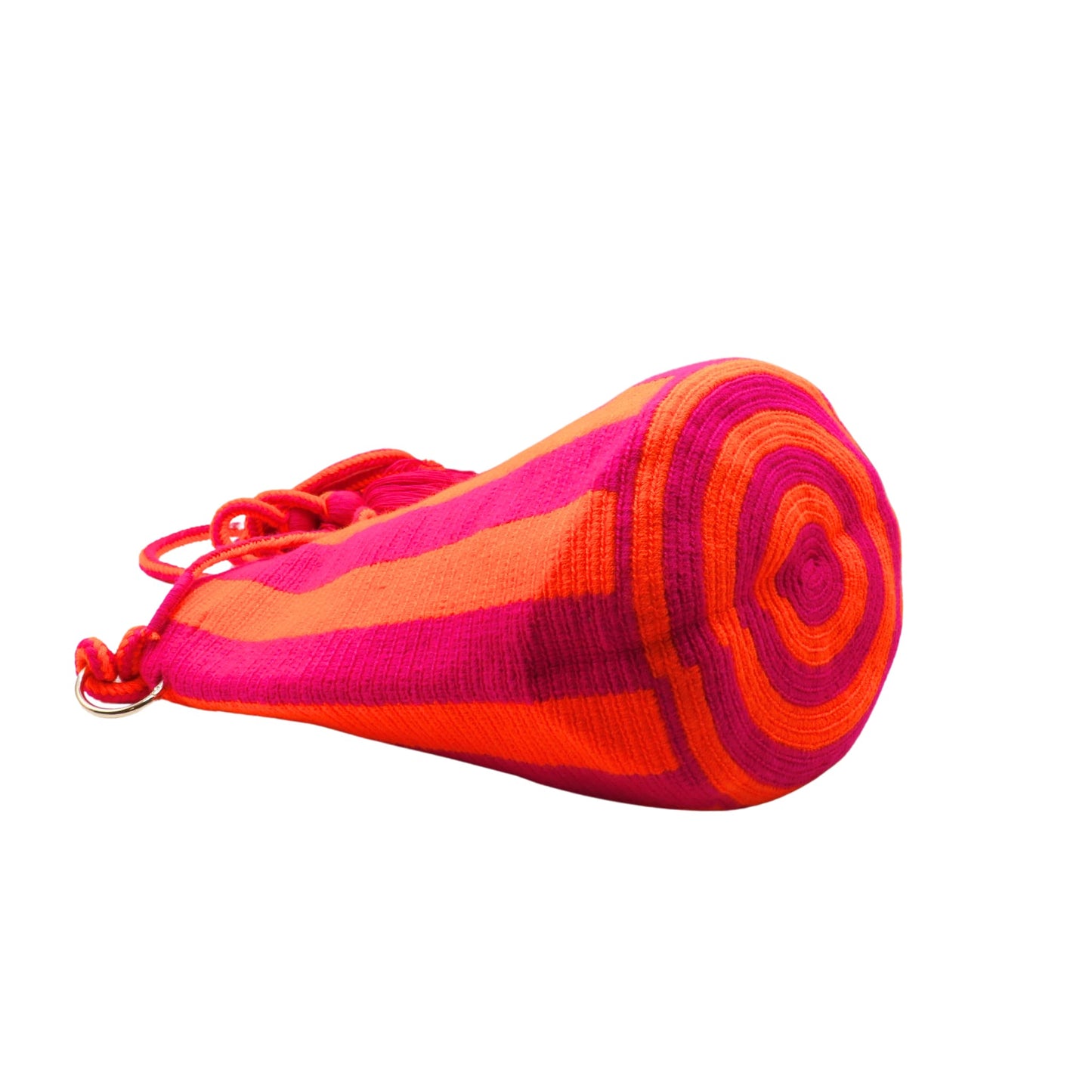 Handmade Wayuu bag with vibrant pink and orange stripes, long woven cord strap, and tassel detail.