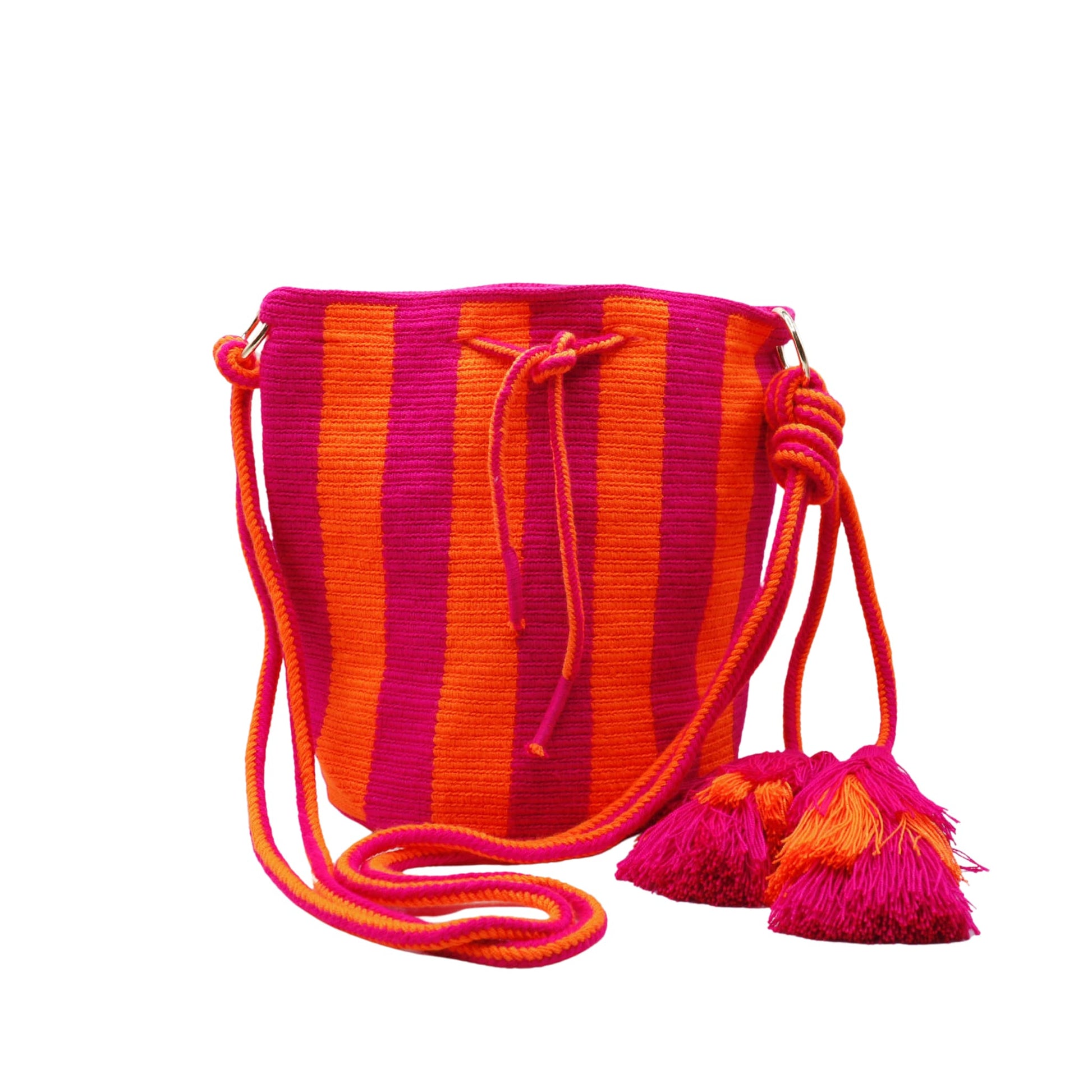 Handmade Wayuu bag with vibrant pink and orange stripes, long woven cord strap, and tassel detail.