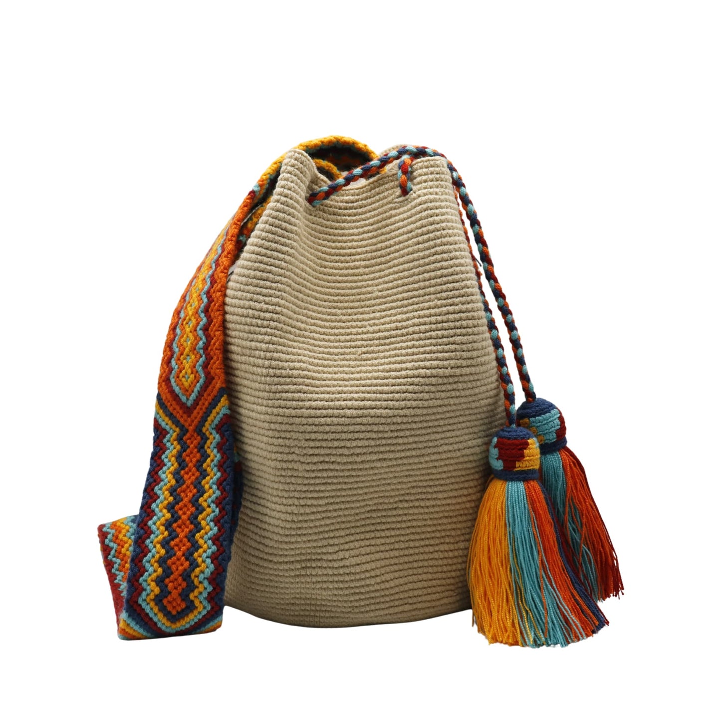 Beige handmade Wayuu bucket bag with a wide multicolored macramé strap featuring orange, yellow, aqua blue, navy, and red geometric patterns. The bag has a textured crochet body, braided drawstring closure, and large colorful tassels.
