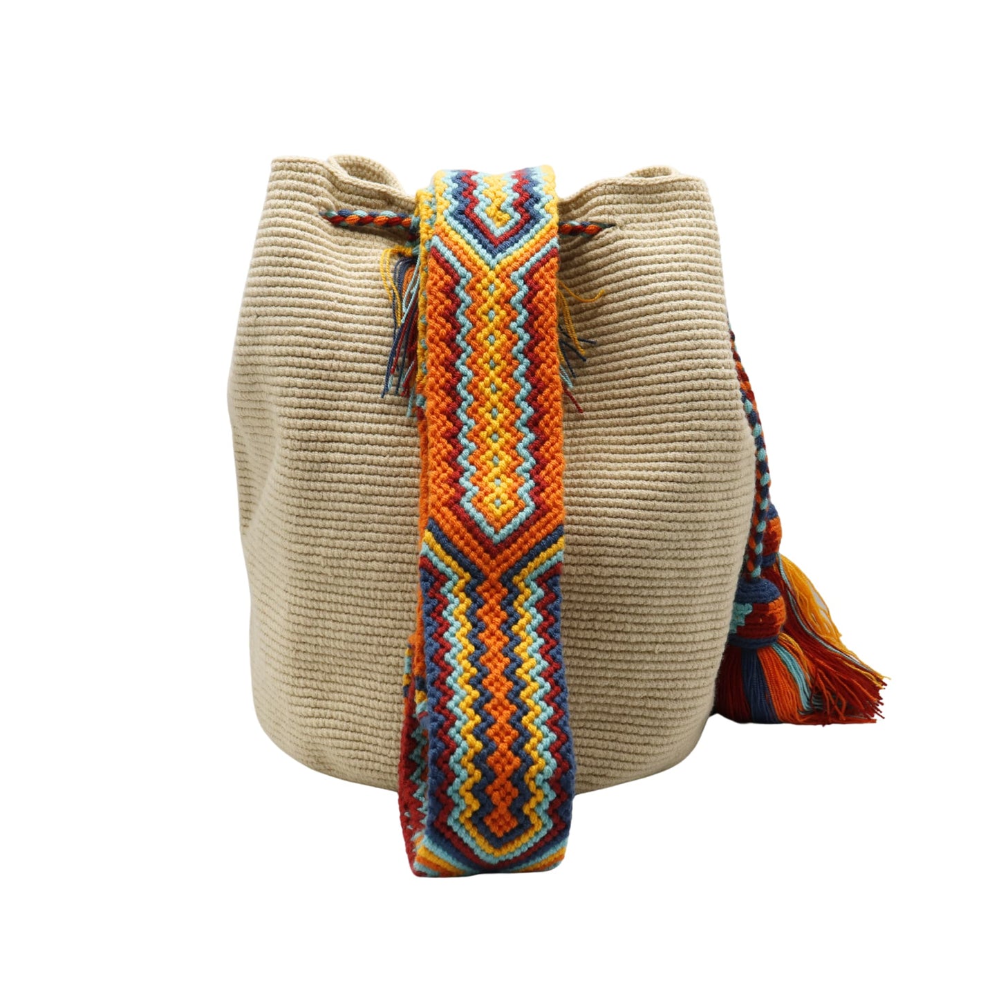 Beige handmade Wayuu bucket bag with a wide multicolored macramé strap featuring orange, yellow, aqua blue, navy, and red geometric patterns. The bag has a textured crochet body, braided drawstring closure, and large colorful tassels.
